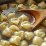 A close-up of a pot of boiling water with gnocchi