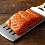 A close-up of a sleek, stainless steel fish turner with