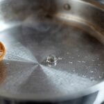 A close-up of a stainless steel pan on a stove,