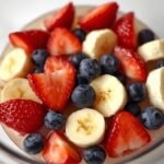 A close-up of a traditional fruit salad in a glass