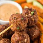 A close-up of crispy ground turkey meatballs on a wooden
