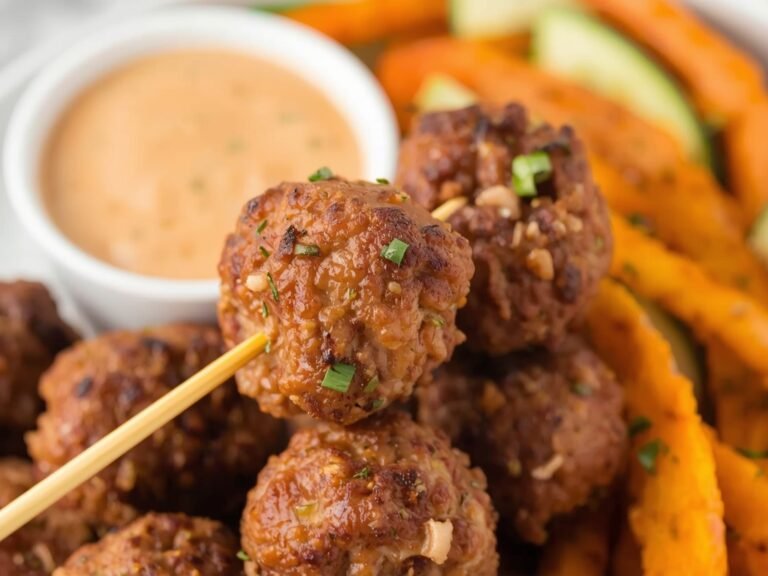 A close-up of crispy ground turkey meatballs on a wooden
